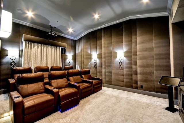 home theater room featuring carpet, vaulted ceiling, and ornamental molding