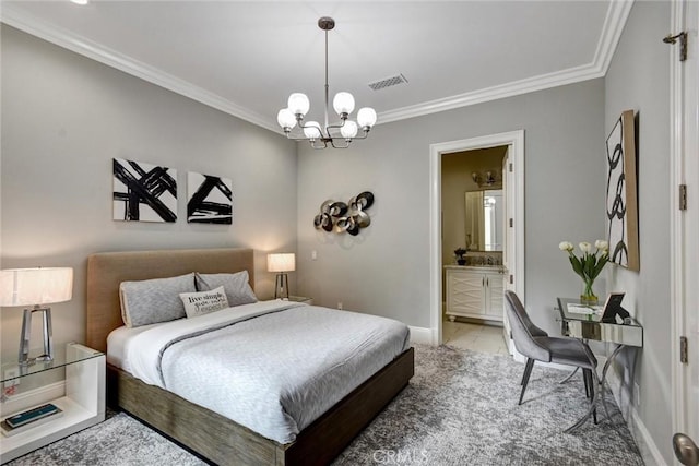 bedroom featuring a notable chandelier, crown molding, and ensuite bath