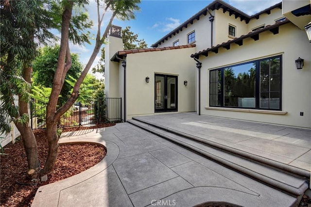 back of property featuring a patio area and french doors