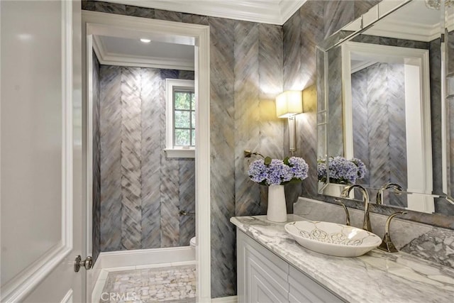 bathroom featuring vanity, toilet, and ornamental molding