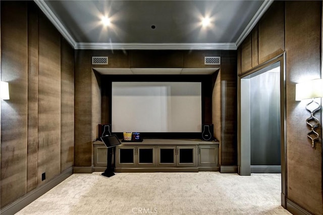 carpeted cinema featuring ornamental molding and wooden walls