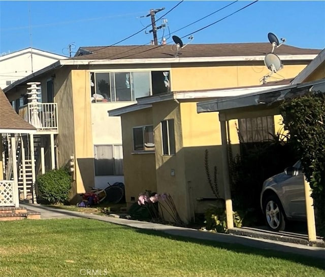 rear view of property featuring a yard