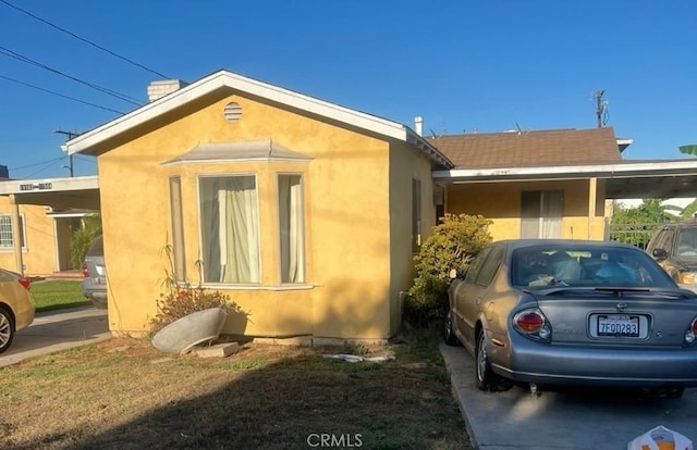 view of home's exterior featuring a carport