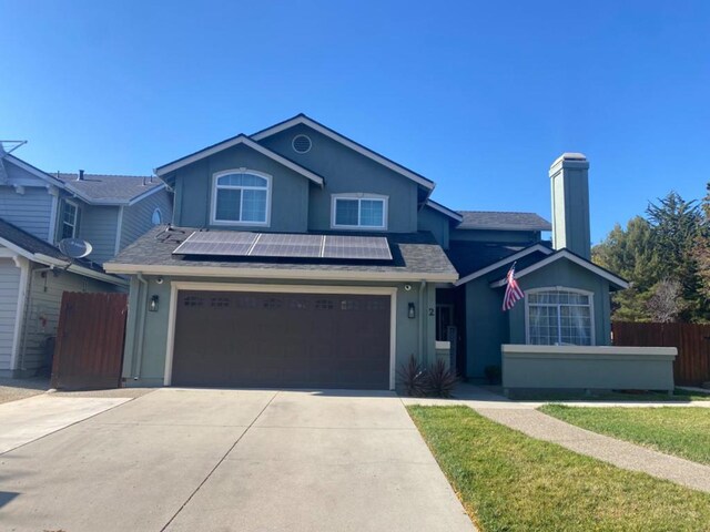 view of front of property featuring solar panels