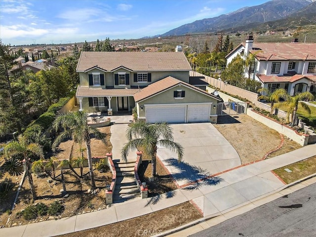 view of front of home with a mountain view and a garage