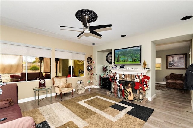 living room featuring hardwood / wood-style floors and ceiling fan