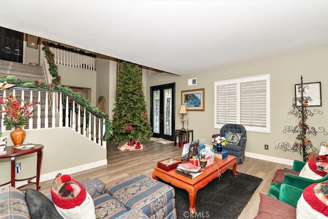 living room with french doors and hardwood / wood-style flooring