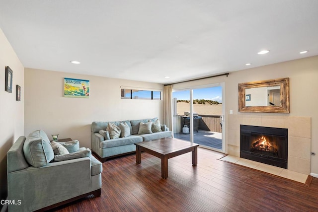 living room featuring hardwood / wood-style floors and a tiled fireplace