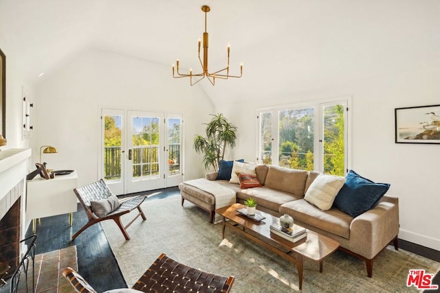 living room featuring hardwood / wood-style flooring, a wealth of natural light, high vaulted ceiling, and a tile fireplace