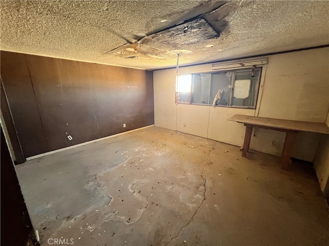 basement featuring a textured ceiling