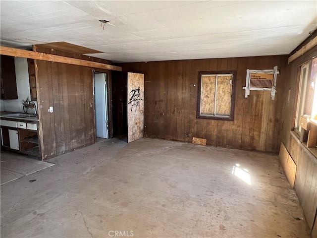 spare room with wooden walls and sink