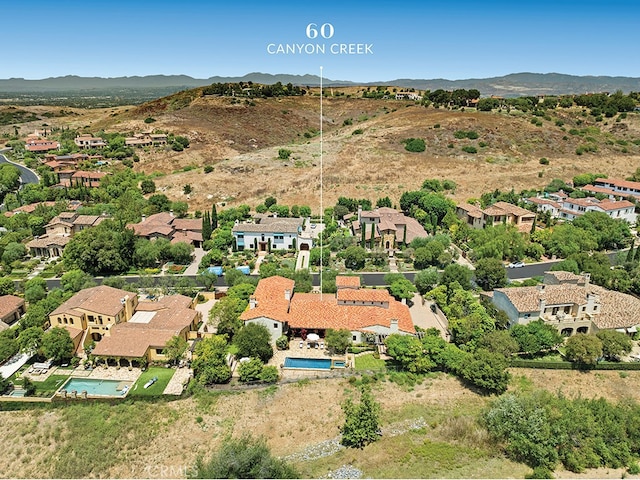 birds eye view of property with a mountain view