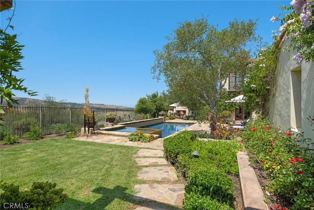 view of yard featuring a patio and a fenced in pool