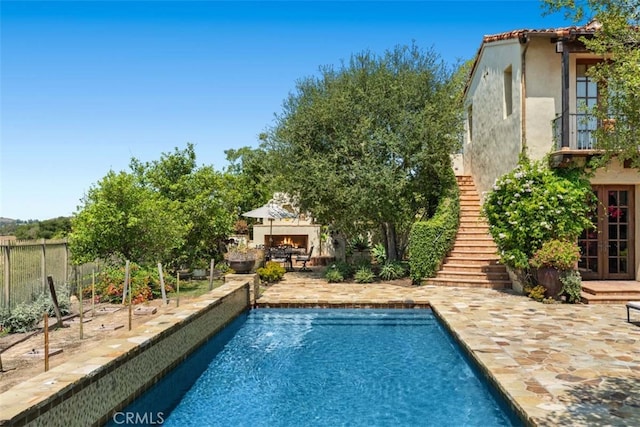 view of swimming pool with a patio area