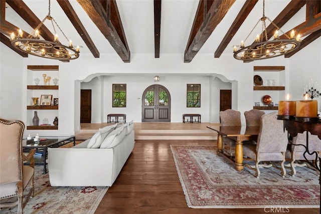 living room featuring an inviting chandelier, beamed ceiling, and dark hardwood / wood-style flooring