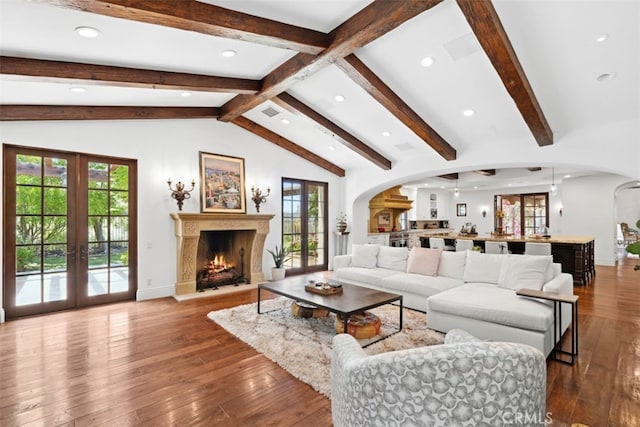 living room with vaulted ceiling with beams, french doors, and hardwood / wood-style flooring