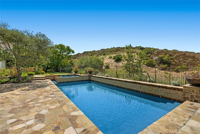 view of pool with an in ground hot tub and a patio area