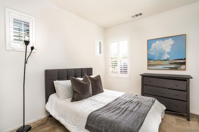 bedroom with light colored carpet