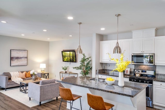 kitchen featuring pendant lighting, dark hardwood / wood-style floors, and stainless steel appliances