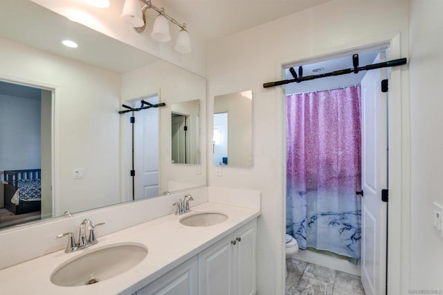 bathroom featuring a shower with shower curtain, vanity, and toilet