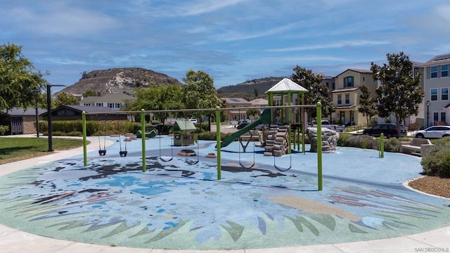 view of community with a mountain view and a playground