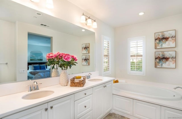 bathroom featuring vanity and a tub