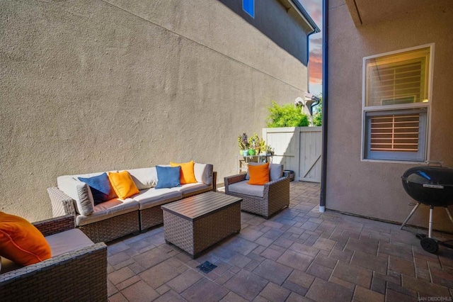 patio terrace at dusk with an outdoor living space and grilling area