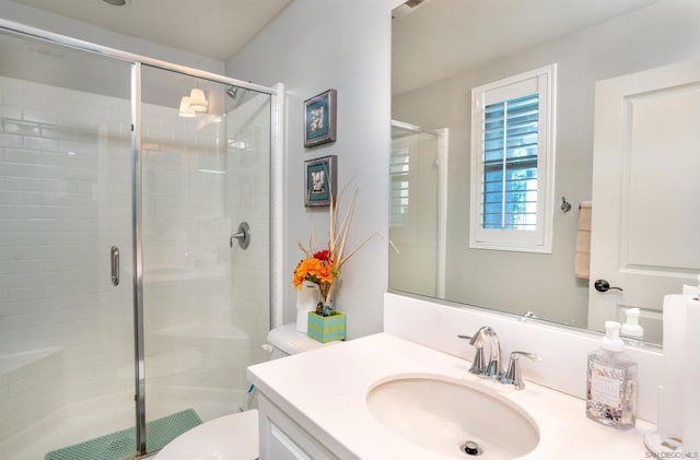 bathroom featuring vanity, toilet, and walk in shower