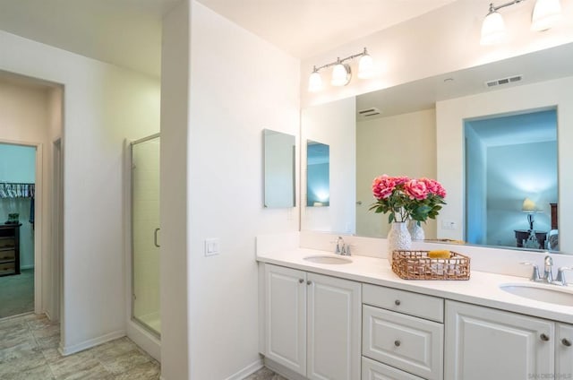 bathroom with vanity and an enclosed shower