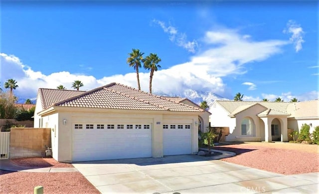 mediterranean / spanish house with a garage