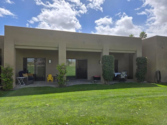 back of property with a patio and a lawn