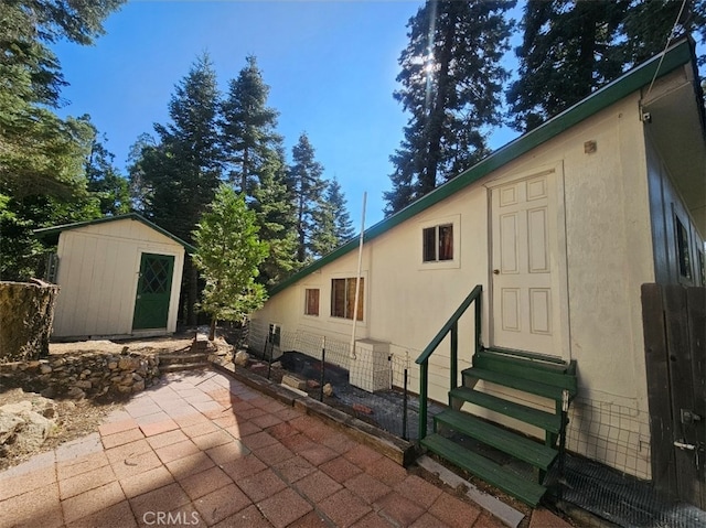 view of patio featuring a storage unit