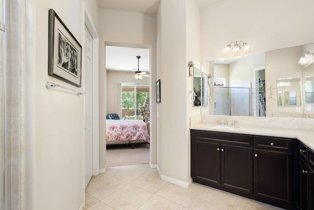 bathroom with ceiling fan, walk in shower, vanity, and tile patterned floors