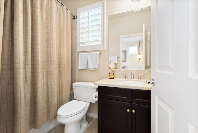 full bathroom featuring toilet, shower / bath combo, and vanity