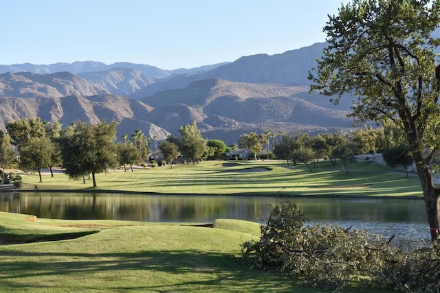 surrounding community with a lawn and a water and mountain view