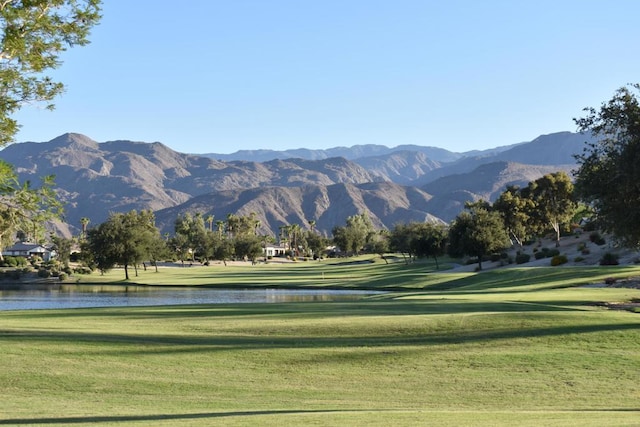 view of home's community featuring a lawn and a water and mountain view