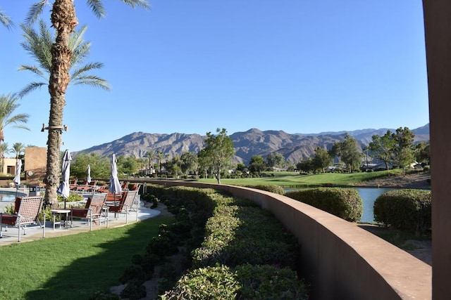 view of home's community featuring a lawn and a water and mountain view