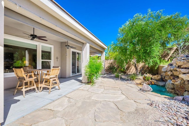 view of patio featuring ceiling fan