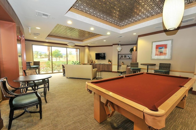 recreation room with a raised ceiling, billiards, ornamental molding, and carpet