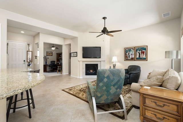 tiled living room featuring ceiling fan