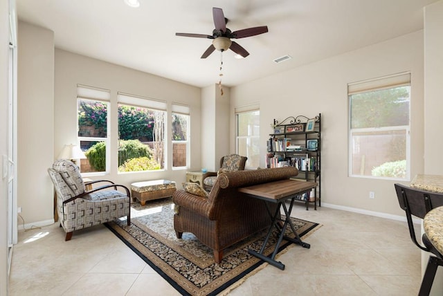 living room featuring ceiling fan and light tile patterned floors