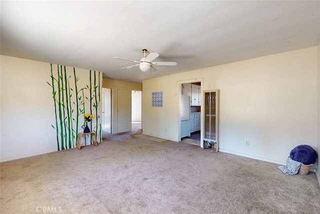 spare room featuring carpet flooring and ceiling fan