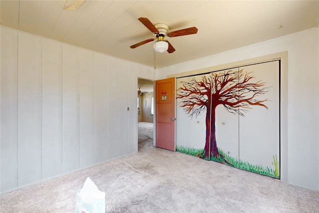 unfurnished bedroom featuring light carpet and ceiling fan