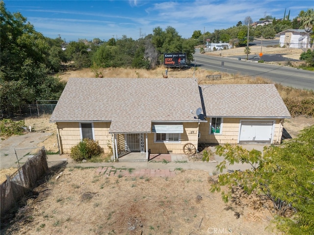 back of property with a garage