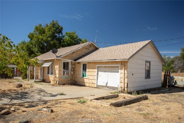 view of front of house with cooling unit and a garage