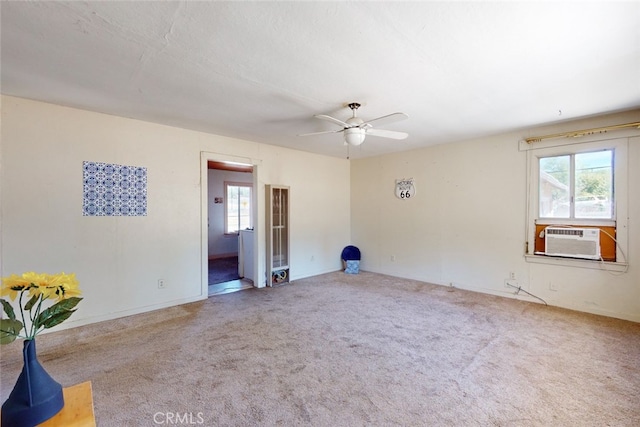 carpeted spare room with cooling unit and ceiling fan