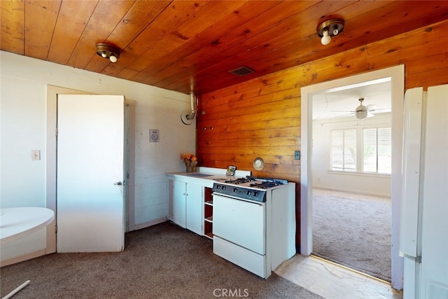 kitchen featuring carpet, white appliances, wood walls, and wood ceiling