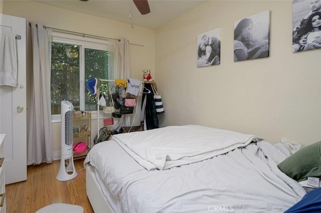 bedroom with ceiling fan and light hardwood / wood-style flooring