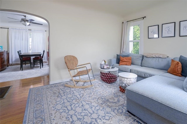 living room with wood-type flooring and ceiling fan