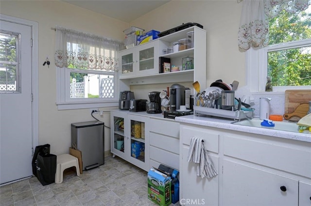 kitchen with white cabinetry and sink